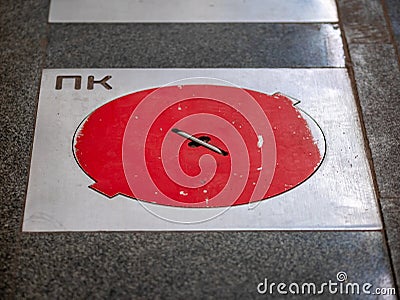 Fire hatches at the Moscow metro station. Red covers on the floor of the platform at the wells with fire hydrants in the subway Stock Photo