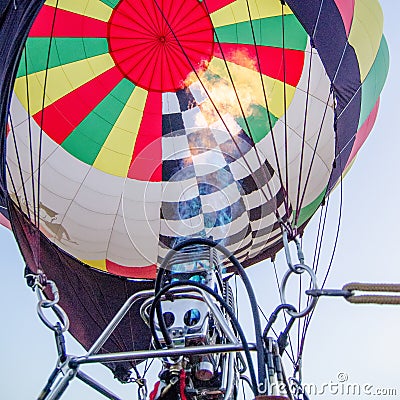 Fire heats the air inside a hot ai r balloon at balloon festival Stock Photo