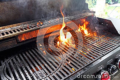 The fire heats up the grate on a gas grill for grilling meat Stock Photo