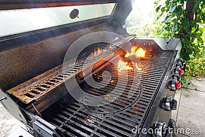 The fire heats up the grate on a gas grill for grilling meat Stock Photo