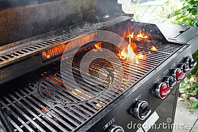 The fire heats up the grate on a gas grill for grilling meat Stock Photo