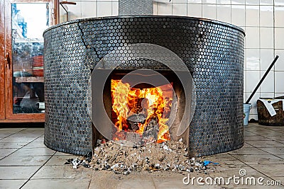 fire heats up a large cooking pot. Stock Photo
