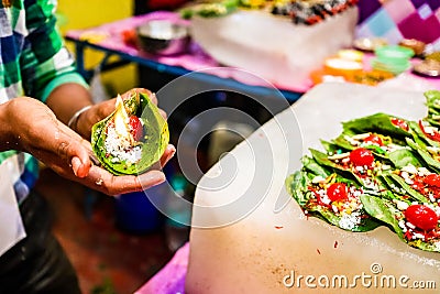 Fire paan, a special variety of flaming betel leaf being prepared in the hands of seller Stock Photo