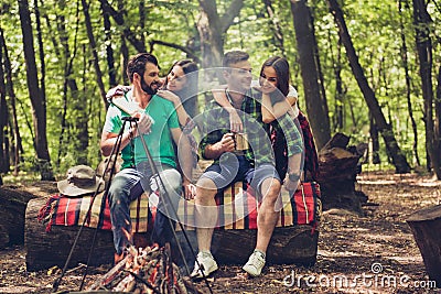 Fire place, two lovely couples, nice forest view. Guys are piggy Stock Photo