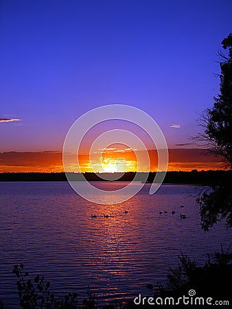 Fire Red Sunrise and a Lake Stock Photo