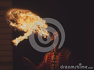 Fire show artist breathe fire in the dark Stock Photo