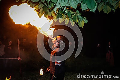 The fire show performed by Belarusian folk ensemble. Editorial Stock Photo