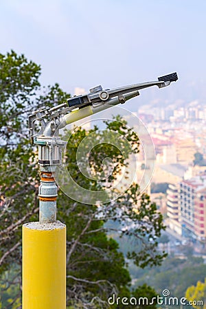 Fire sprinkler with a nozzle valve incorporated. An heavy-duty part of the fire protection system of forest or park green Stock Photo