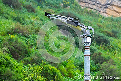 Fire sprinkler with a nozzle valve incorporated. An heavy-duty part of the fire protection system of forest or park green Stock Photo