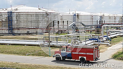 Fire truck in industrial plant. A large red fire rescue vehicle in the chemistry refinary plant. Fire safety concept Stock Photo