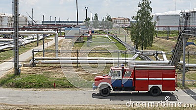 Fire truck in industrial plant. A large red fire rescue vehicle in the chemistry refinary plant. Fire safety concept Stock Photo