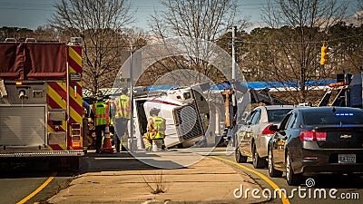 Carrboro NC, /US-March 10 2017:Fire truck and police cars with overturned logging truck Editorial Stock Photo