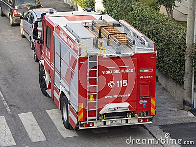 Red fire truck in the streets of the city to provide first aid in case of emergency. Tank lorry. Street of Italy Editorial Stock Photo