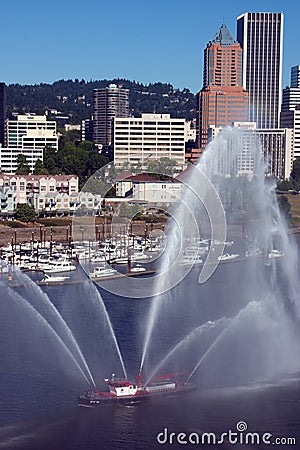 Fireboat in front of marina, city. Stock Photo