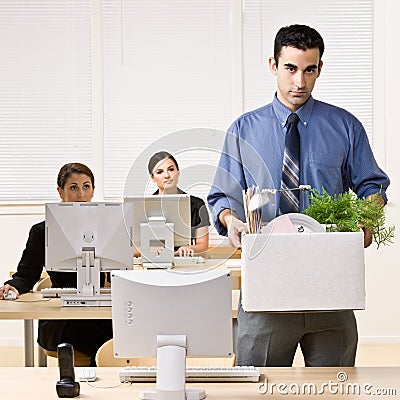 Fired businessman carrying box Stock Photo