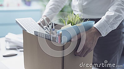 Fired office worker packing his belongings Stock Photo