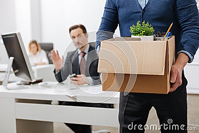 Fired senior employee leaving the office with the box Stock Photo