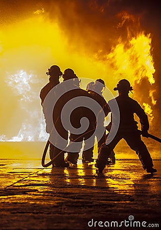 Firefighter bracing during firefighting Editorial Stock Photo