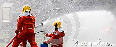Firefighter Concept. Fireman using water and extinguisher to fighting with fire flame. firefighters fighting a fire with a hose an Stock Photo