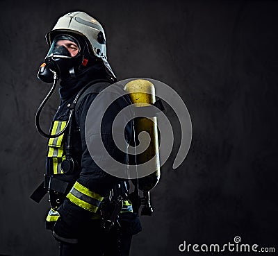 Firefighter dressed in uniform and an oxygen mask. Stock Photo