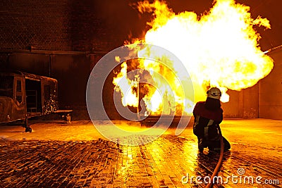 Firefighter extinguishes a fire Stock Photo