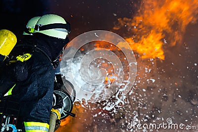 Firefighter - Firemen extinguishing a large blaze Stock Photo