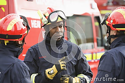 A firefighter giving instructions to his team Stock Photo