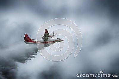 Firefighter plane dropping water Editorial Stock Photo