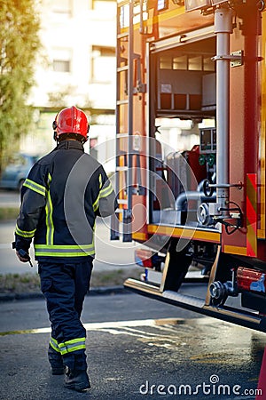 Firefighter in protective clothing, helmets and mask. Fireman in fire fighting operation Stock Photo