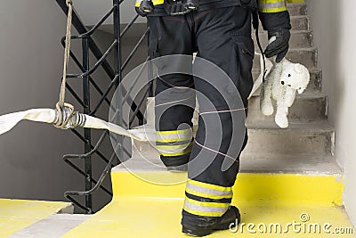 Firefighter rescued a teddy bear child Stock Photo