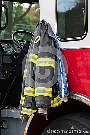 Firefighter suit Hanging on the Door of Fire Truck Stock Photo