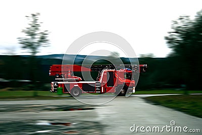 Firefighter truck driving fast on a wet road Editorial Stock Photo