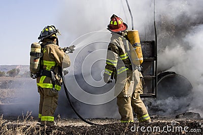 Firefighters in action Stock Photo