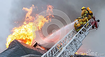 Firefighters battle blazing house fire Editorial Stock Photo