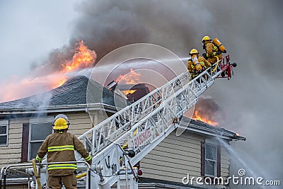 Firefighters battle blazing house fire Editorial Stock Photo