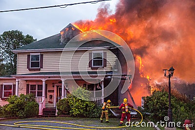 Firefighters battle blazing house fire Editorial Stock Photo