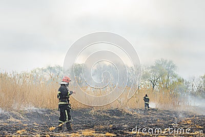 Firefighters battle a wildfire. firefighters spray water to wildfire. Australia bushfires, The fire is fueled by wind and heat Stock Photo