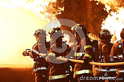 Firefighters Battling Flames Stock Photo