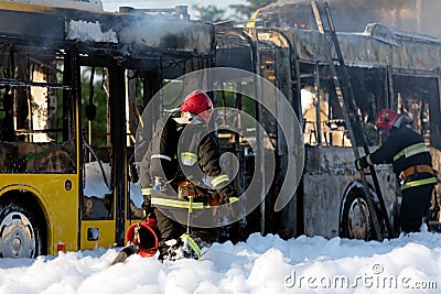 Firefighters extinguish burning coach with foam Editorial Stock Photo