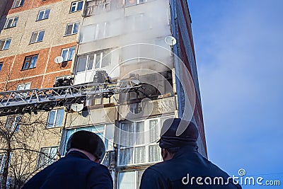 Firefighters extinguish a fire while climbing the stairs, risking their lives in danger in a multi-story building Editorial Stock Photo