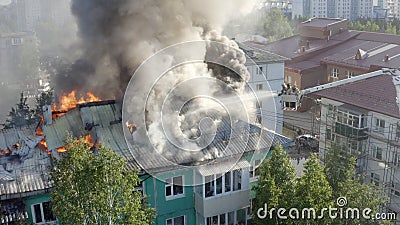 Firefighters extinguish a fire on the roof of a residential highrise building. top view Editorial Stock Photo