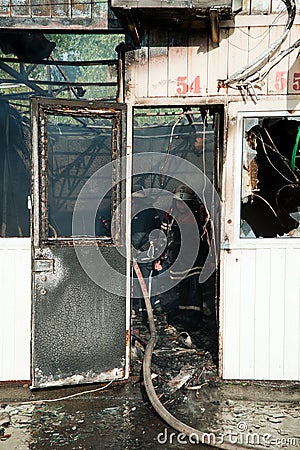 Firefighters extinguish a large fire at Troyeschina market with water and fire extinguishers Editorial Stock Photo