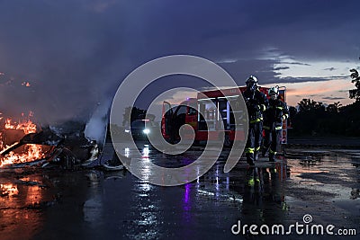 Firefighters fight the fire flame to control fire not to spreading out. Firefighter industrial and public safety concept Stock Photo