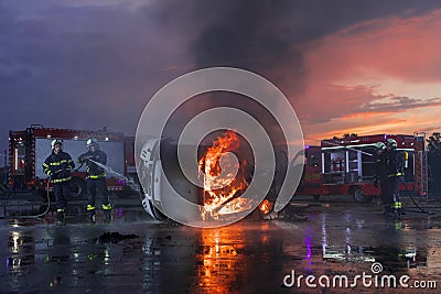 Firefighters fight the fire flame to control fire not to spreading out. Firefighter industrial and public safety concept Stock Photo