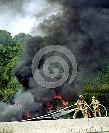 Firefighters fight a very smoky car fire Stock Photo