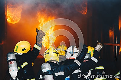 Firefighters fighting fire Stock Photo