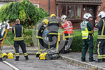 Firefighters getting dressed in safety gear preparing enter home with suspect chemical incident Editorial Stock Photo