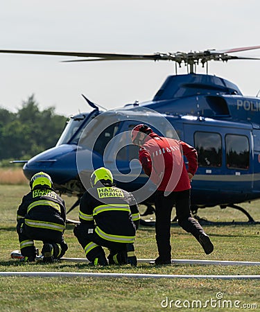 Firefighters getting ready for filling water bucket Editorial Stock Photo