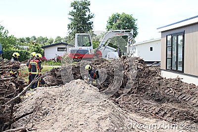 Firefighters must take action if a gas pipe is hit during excavation work Editorial Stock Photo