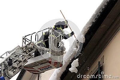 Firefighters remove snow from the eaves Editorial Stock Photo